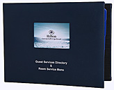 Padded guest directory with die-cut window to hold 4 color photo with silver foil stamped logo.