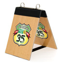 Flip top table tent with logo printed 4 color onto rubberized material, laminated and mounted onto Masonite board.